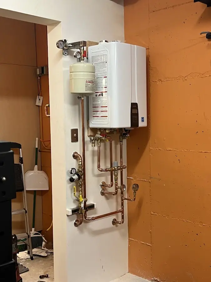 Plumbing technician inspecting water heater connections in Savannah